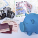 Piggy bank with dream destination sketch, passport book/  saving