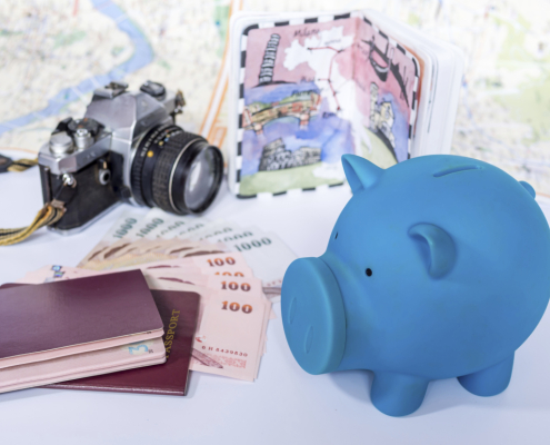 Piggy bank with dream destination sketch, passport book/  saving